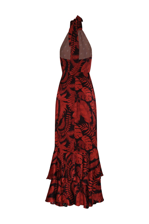 Back view of a cherry red and black tropical print silk jacquard maxi dress with a tiered ruffle hem.