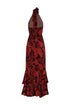 Back view of a cherry red and black tropical print silk jacquard maxi dress with a tiered ruffle hem.