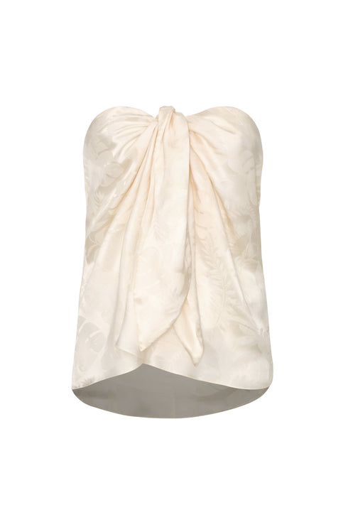 Ivory silk jacquard strapless blouse with a front-tie sarong-style drape and rainforest pattern.