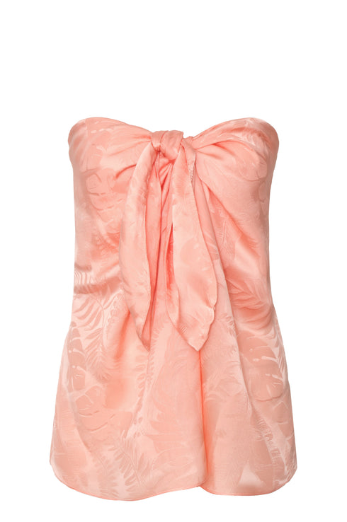 Peach strapless silk jacquard blouse with a front tie knot and subtle leaf pattern.