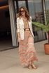 Woman wearing the Solana Embroidered Mesh Maxi Skirt in Peach Palms with a white blazer.